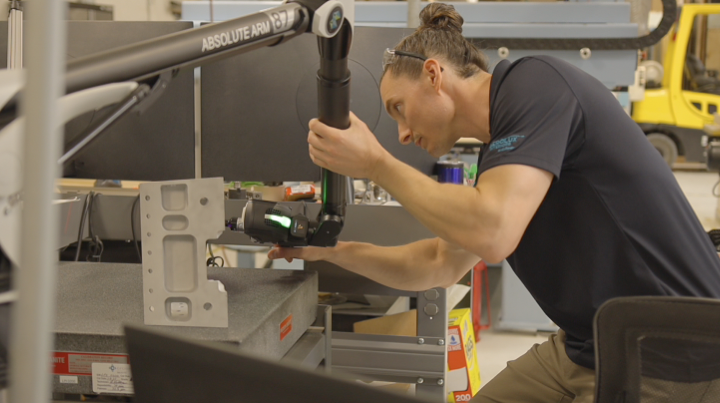 Liberty Partners quality inspector verifying an aerospace component with a portable CMM laser scanner